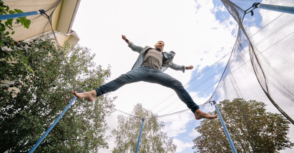 トランポリンによる健康効果を感じている大人の男女が笑顔で運動している様子の16:9画像